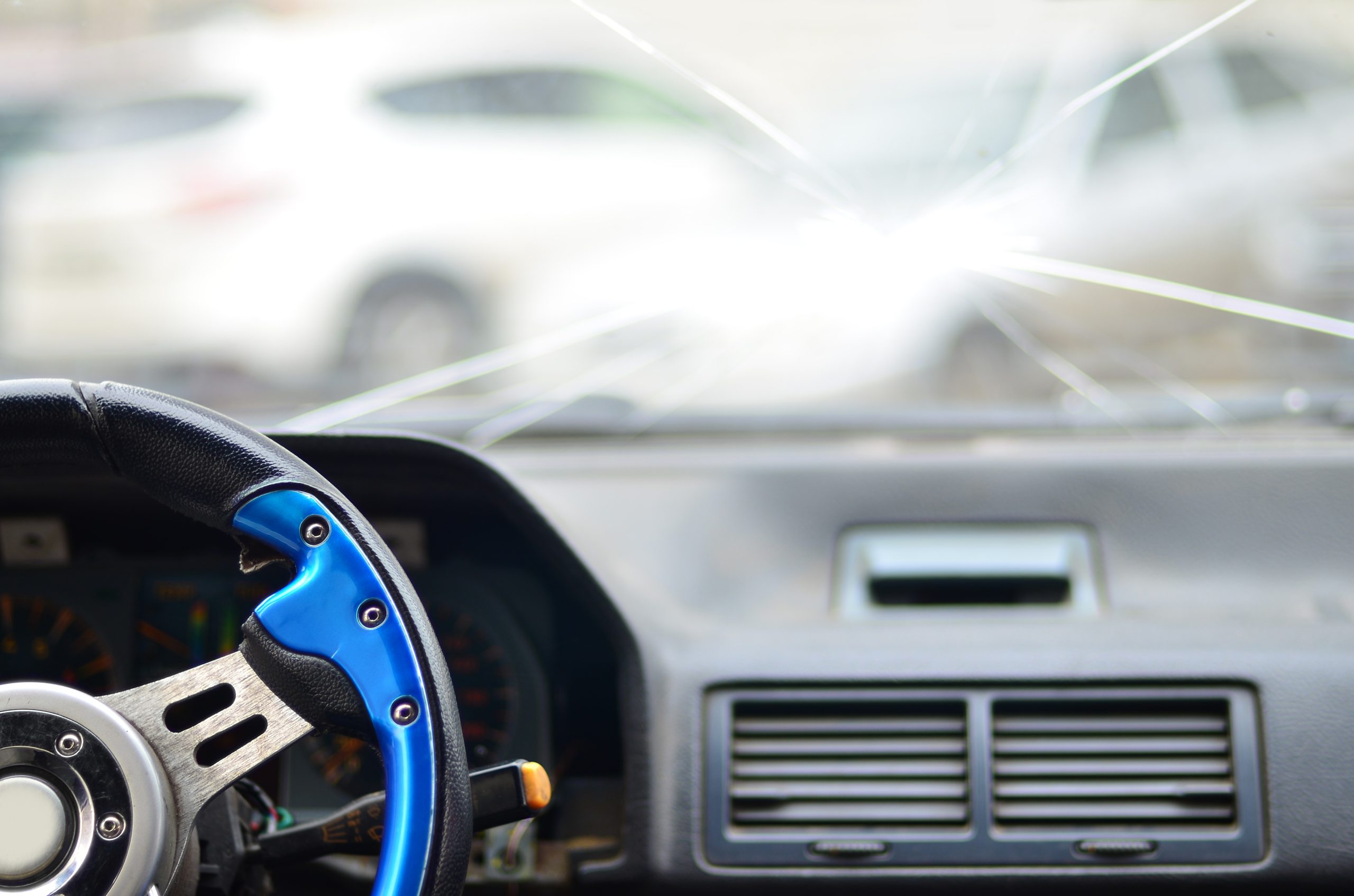 Interior of a car during a traffic accident. View through the driver's eyes in the car with a broken windshield. The concept of inattentive and sloppy driving